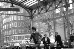 Mr. George Harrison running into Marylebone railroad Station in London during the filming of A Hard Day's Night (1964)