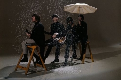 12-The Beatles sitting on a trestle under a simulated snow shower during the making of a promotional film for their single 'I Feel Fine', November 1965.