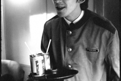 Bill Eppridge, 1964 George Harrison wearing a train porter’s jacket on his way to Washington D.C.