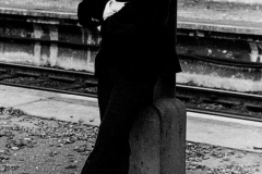 John Lennon at a Beatles' photo shoot by a train station, 1964.