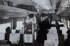 John Lennon, pictured waiting behind a buffet trolley, while the Beatles travelled by train