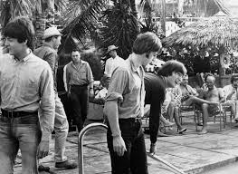 The Beatles, working on a movie in Nassau, Bahamas, went swimming in a pool February 23, 1965 with their clothes on while filming.