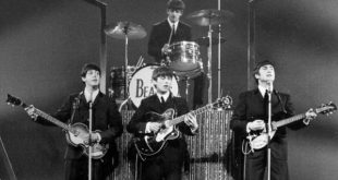 Beatles play guitars chin-high