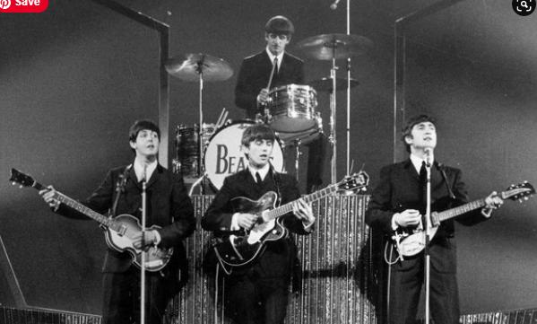 Beatles play guitars chin-high